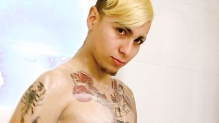 tattooed twink washing carefully